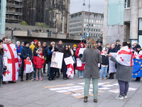 Dozens of people take part in a pro-EU demonstration for Georgia and support the crackdown in Georgia in Cologne, Germany, on December 8, 20...