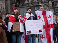 Dozens of people take part in a pro-EU demonstration for Georgia and support the crackdown in Georgia in Cologne, Germany, on December 8, 20...