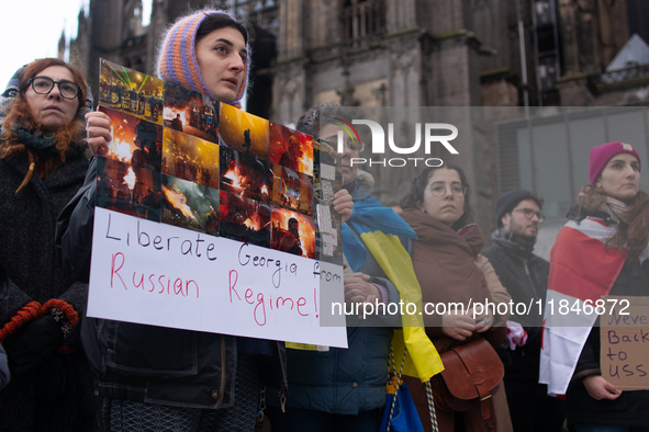 Dozens of people take part in a pro-EU demonstration for Georgia and support the crackdown in Georgia in Cologne, Germany, on December 8, 20...