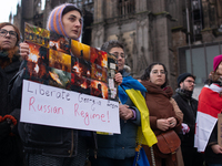 Dozens of people take part in a pro-EU demonstration for Georgia and support the crackdown in Georgia in Cologne, Germany, on December 8, 20...