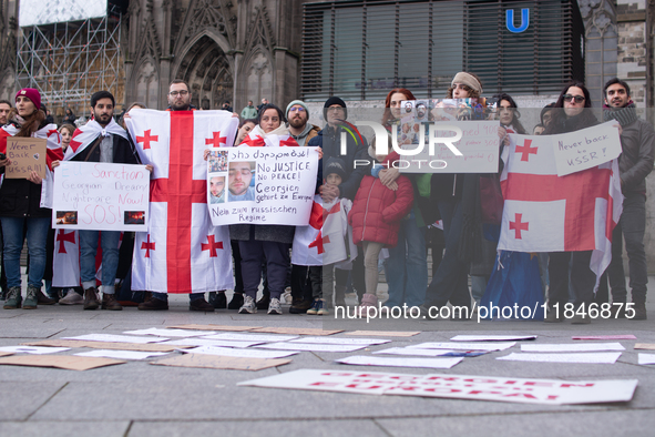 Dozens of people take part in a pro-EU demonstration for Georgia and support the crackdown in Georgia in Cologne, Germany, on December 8, 20...