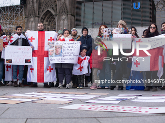 Dozens of people take part in a pro-EU demonstration for Georgia and support the crackdown in Georgia in Cologne, Germany, on December 8, 20...