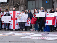 Dozens of people take part in a pro-EU demonstration for Georgia and support the crackdown in Georgia in Cologne, Germany, on December 8, 20...