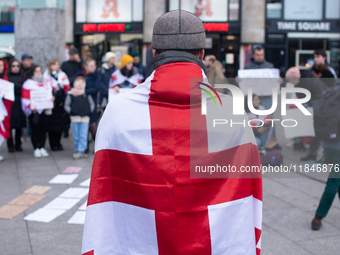 Dozens of people take part in a pro-EU demonstration for Georgia and support the crackdown in Georgia in Cologne, Germany, on December 8, 20...