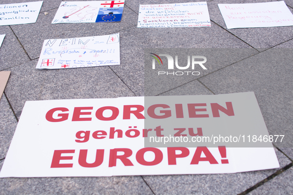 Dozens of people take part in a pro-EU demonstration for Georgia and support the crackdown in Georgia in Cologne, Germany, on December 8, 20...