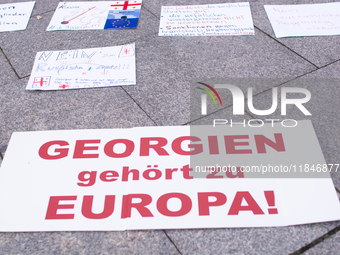 Dozens of people take part in a pro-EU demonstration for Georgia and support the crackdown in Georgia in Cologne, Germany, on December 8, 20...