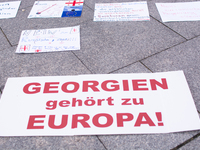 Dozens of people take part in a pro-EU demonstration for Georgia and support the crackdown in Georgia in Cologne, Germany, on December 8, 20...