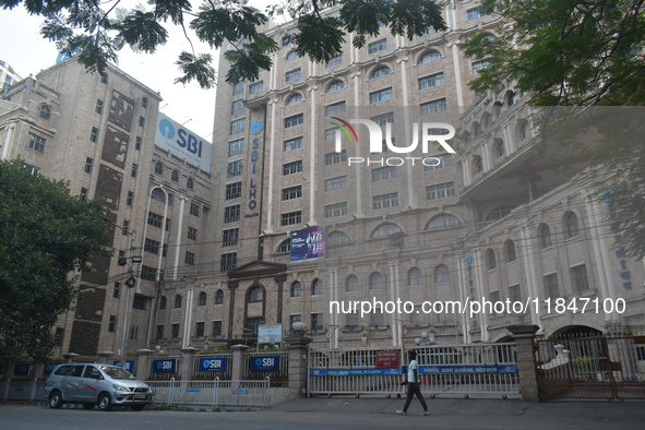 A person passes next to an SBI bank's local head office in Kolkata, India, on December 8, 2024. 