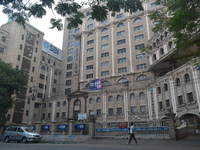 A person passes next to an SBI bank's local head office in Kolkata, India, on December 8, 2024. (