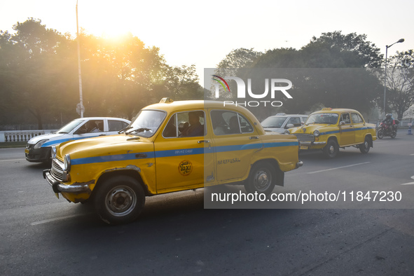 Yellow taxis move on the road in Kolkata, India, on December 8, 2024. Kolkata says goodbye to its yellow taxis. A court order removes older...