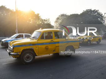 Yellow taxis move on the road in Kolkata, India, on December 8, 2024. Kolkata says goodbye to its yellow taxis. A court order removes older...