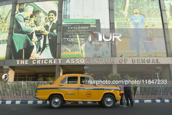 Shambhu Prasad, a yellow taxi driver, takes a selfie with his son along his yellow taxi in front of Eaden Gardens in Kolkata, India, on Dece...