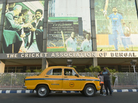 Shambhu Prasad, a yellow taxi driver, takes a selfie with his son along his yellow taxi in front of Eaden Gardens in Kolkata, India, on Dece...