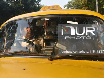 Akshil Yadav drives his yellow taxi in Kolkata, India, on December 8, 2024. Kolkata says goodbye to its yellow taxis. A court order removes...