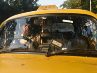 Akshil Yadav drives his yellow taxi in Kolkata, India, on December 8, 2024. Kolkata says goodbye to its yellow taxis. A court order removes...