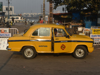 A yellow taxi driver sits inside his taxi and reads his newspaper in Kolkata, India, on December 8, 2024. Kolkata says goodbye to its yellow...