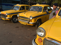 Yellow taxi drivers stand at a taxi stand in Kolkata, India, on December 8, 2024. Kolkata says goodbye to its yellow taxis. A court order re...