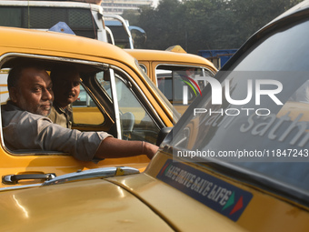 Yellow taxi drivers stand at a taxi stand in Kolkata, India, on December 8, 2024. Kolkata says goodbye to its yellow taxis. A court order re...