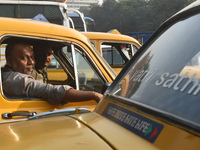 Yellow taxi drivers stand at a taxi stand in Kolkata, India, on December 8, 2024. Kolkata says goodbye to its yellow taxis. A court order re...