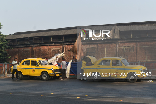 Yellow taxi drivers stand at a taxi stand in Kolkata, India, on December 8, 2024. Kolkata says goodbye to its yellow taxis. A court order re...