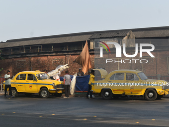 Yellow taxi drivers stand at a taxi stand in Kolkata, India, on December 8, 2024. Kolkata says goodbye to its yellow taxis. A court order re...