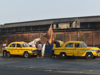 Yellow taxi drivers stand at a taxi stand in Kolkata, India, on December 8, 2024. Kolkata says goodbye to its yellow taxis. A court order re...