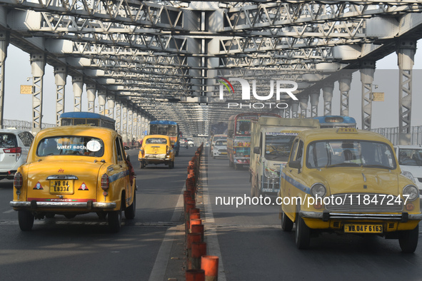 Yellow taxis move on the road in Kolkata, India, on December 8, 2024. Kolkata says goodbye to its yellow taxis. A court order removes older...