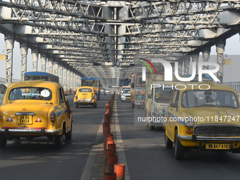 Yellow taxis move on the road in Kolkata, India, on December 8, 2024. Kolkata says goodbye to its yellow taxis. A court order removes older...