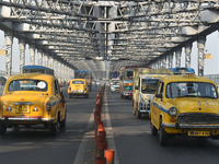 Yellow taxis move on the road in Kolkata, India, on December 8, 2024. Kolkata says goodbye to its yellow taxis. A court order removes older...