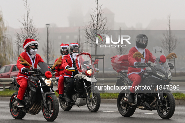 KRAKOW, POLAND - DECEMBER 08: Hundreds of motorcycle riders dressed as Santa Claus on their way to deliver Christmas gifts to young patients...