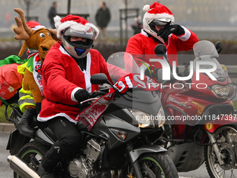 KRAKOW, POLAND - DECEMBER 08: Hundreds of motorcycle riders dressed as Santa Claus on their way to deliver Christmas gifts to young patients...