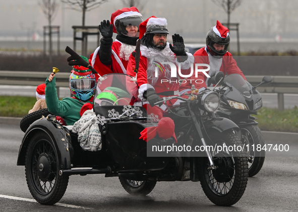 KRAKOW, POLAND - DECEMBER 08: Hundreds of motorcycle riders dressed as Santa Claus deliver Christmas gifts to young patients at the Pediatri...