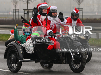 KRAKOW, POLAND - DECEMBER 08: Hundreds of motorcycle riders dressed as Santa Claus deliver Christmas gifts to young patients at the Pediatri...