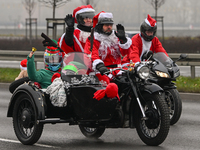 KRAKOW, POLAND - DECEMBER 08: Hundreds of motorcycle riders dressed as Santa Claus deliver Christmas gifts to young patients at the Pediatri...