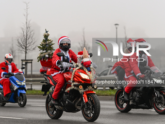 KRAKOW, POLAND - DECEMBER 08: Hundreds of motorcycle riders dressed as Santa Claus on their way to deliver Christmas gifts to young patients...