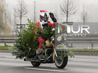 KRAKOW, POLAND - DECEMBER 08: Hundreds of motorcycle riders dressed as Santa Claus on their way to deliver Christmas gifts to young patients...