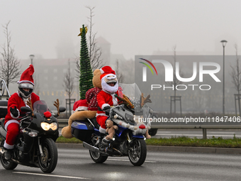 KRAKOW, POLAND - DECEMBER 08: Hundreds of motorcycle riders dressed as Santa Claus on their way to deliver Christmas gifts to young patients...