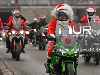 KRAKOW, POLAND - DECEMBER 08: Hundreds of motorcycle riders dressed as Santa Claus on their way to deliver Christmas gifts to young patients...