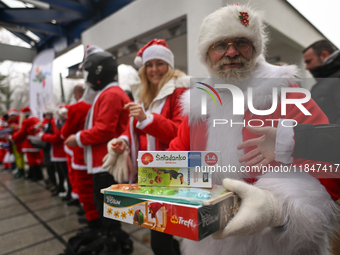 KRAKOW, POLAND - DECEMBER 08: Hundreds of motorcycle riders dressed as Santa Claus form a human chain to deliver Christmas gifts to young pa...