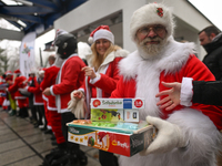 KRAKOW, POLAND - DECEMBER 08: Hundreds of motorcycle riders dressed as Santa Claus form a human chain to deliver Christmas gifts to young pa...