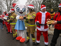 KRAKOW, POLAND - DECEMBER 08: Hundreds of motorcycle riders dressed as Santa Claus form a human chain to deliver Christmas gifts to young pa...