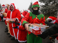 KRAKOW, POLAND - DECEMBER 08: Hundreds of motorcycle riders dressed as Santa Claus form a human chain to deliver Christmas gifts to young pa...