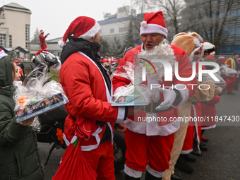 KRAKOW, POLAND - DECEMBER 08: Hundreds of motorcycle riders dressed as Santa Claus form a human chain to deliver Christmas gifts to young pa...