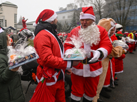 KRAKOW, POLAND - DECEMBER 08: Hundreds of motorcycle riders dressed as Santa Claus form a human chain to deliver Christmas gifts to young pa...