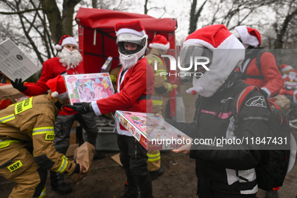 KRAKOW, POLAND - DECEMBER 08: Hundreds of motorcycle riders dressed as Santa Claus form a human chain to deliver Christmas gifts to young pa...