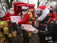 KRAKOW, POLAND - DECEMBER 08: Hundreds of motorcycle riders dressed as Santa Claus form a human chain to deliver Christmas gifts to young pa...