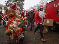 KRAKOW, POLAND - DECEMBER 08: Hundreds of motorcycle riders dressed as Santa Claus form a human chain to deliver Christmas gifts to young pa...