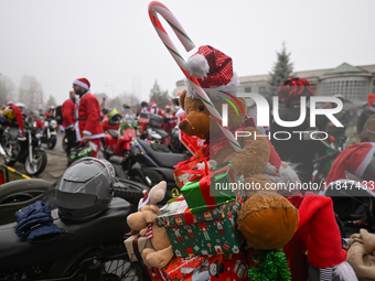 KRAKOW, POLAND - DECEMBER 08: Hundreds of motorcycles parked outside the Pediatric Hospital in Krakow as Santa Clauses deliver Christmas gif...