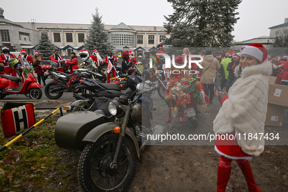 KRAKOW, POLAND - DECEMBER 08: Hundreds of motorcycle riders dressed as Santa Claus form a human chain to deliver Christmas gifts to young pa...