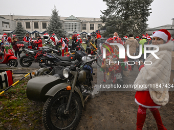 KRAKOW, POLAND - DECEMBER 08: Hundreds of motorcycle riders dressed as Santa Claus form a human chain to deliver Christmas gifts to young pa...